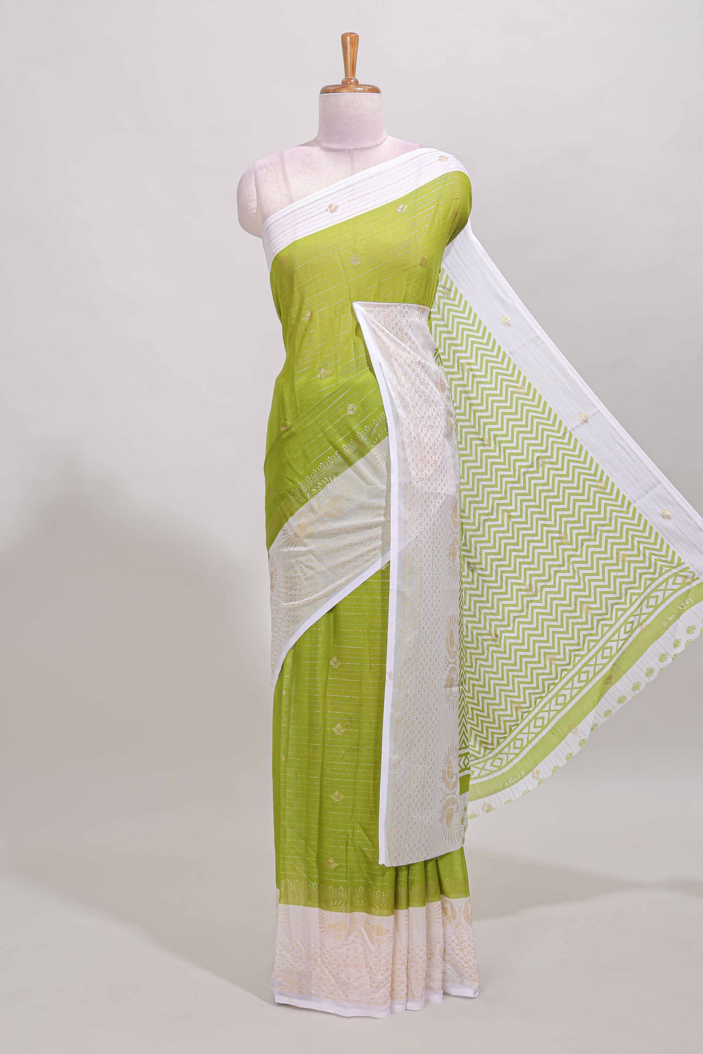 Green zari striped dola silk saree with contrast zari border and blouse