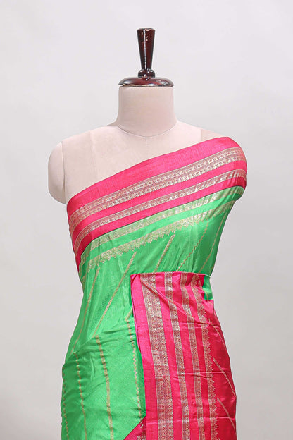 Neon green zari striped saree in dola silk with contrast woven border and blouse