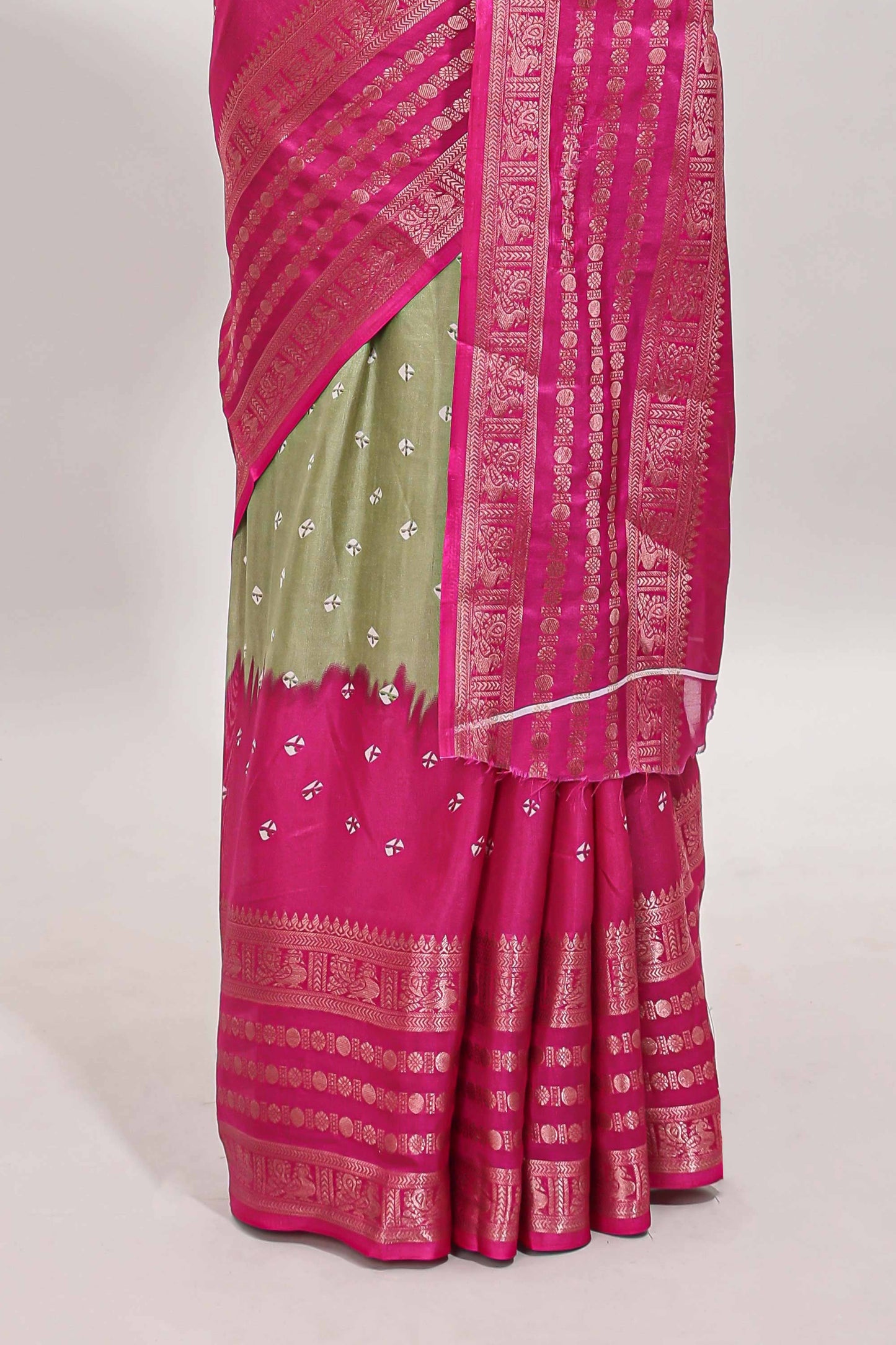 Green unique buttas dola silk saree with contrast zari border and blouse