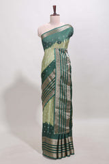 Green unique buttas dola silk saree with contrast dark green zari border and blouse