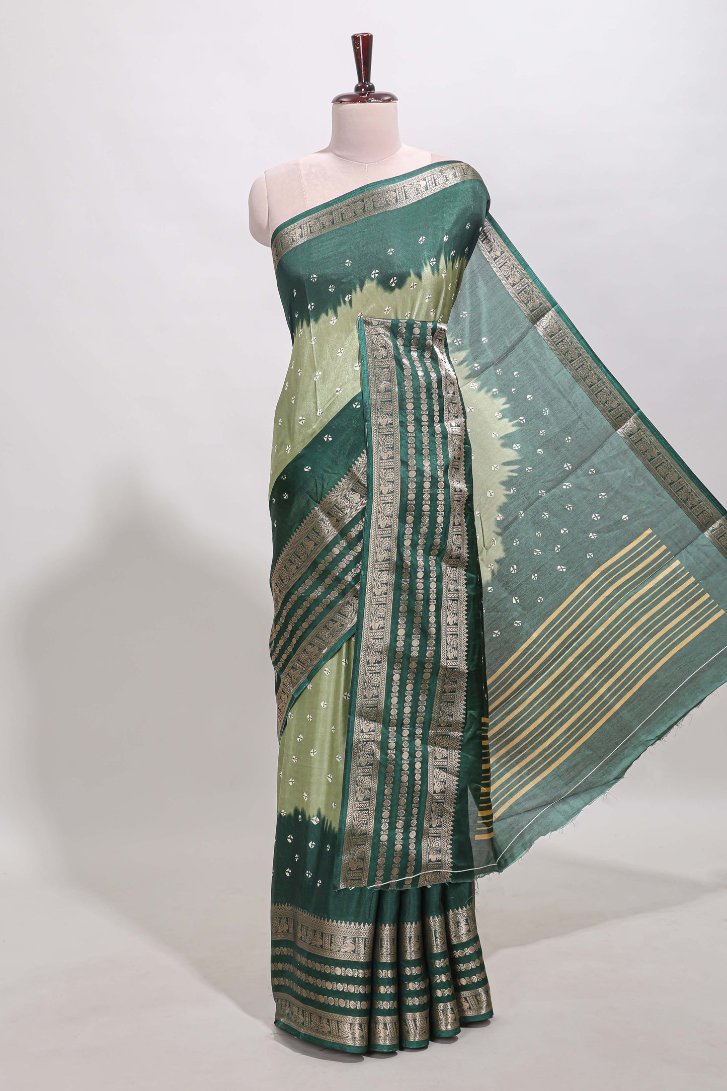 Green unique buttas dola silk saree with contrast dark green zari border and blouse