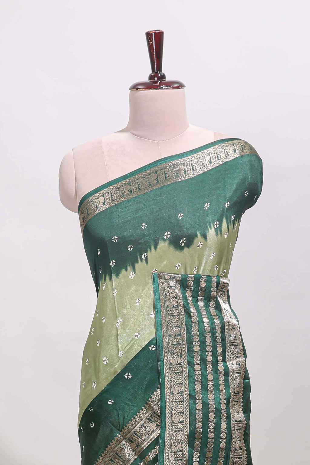 Green unique buttas dola silk saree with contrast dark green zari border and blouse