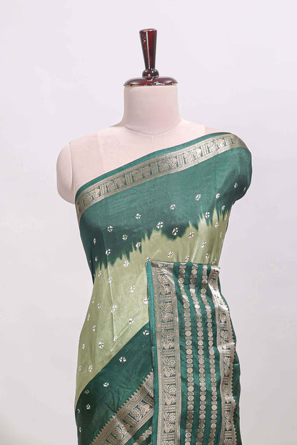 Green unique buttas dola silk saree with contrast dark green zari border and blouse