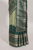 Green unique buttas dola silk saree with contrast dark green zari border and blouse