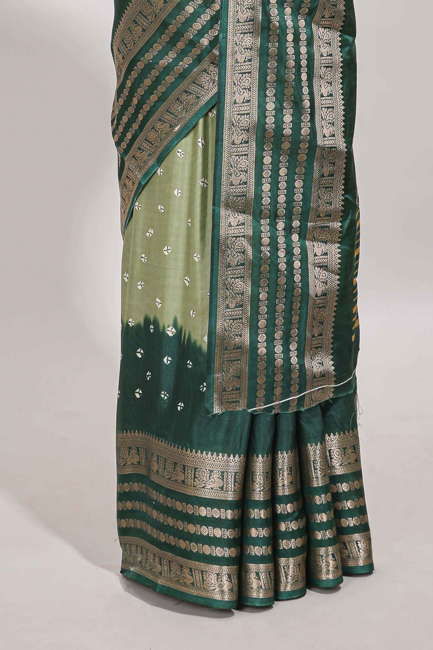 Green unique buttas dola silk saree with contrast dark green zari border and blouse