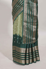 Green unique buttas dola silk saree with contrast dark green zari border and blouse