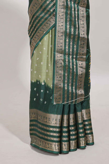 Green unique buttas dola silk saree with contrast dark green zari border and blouse