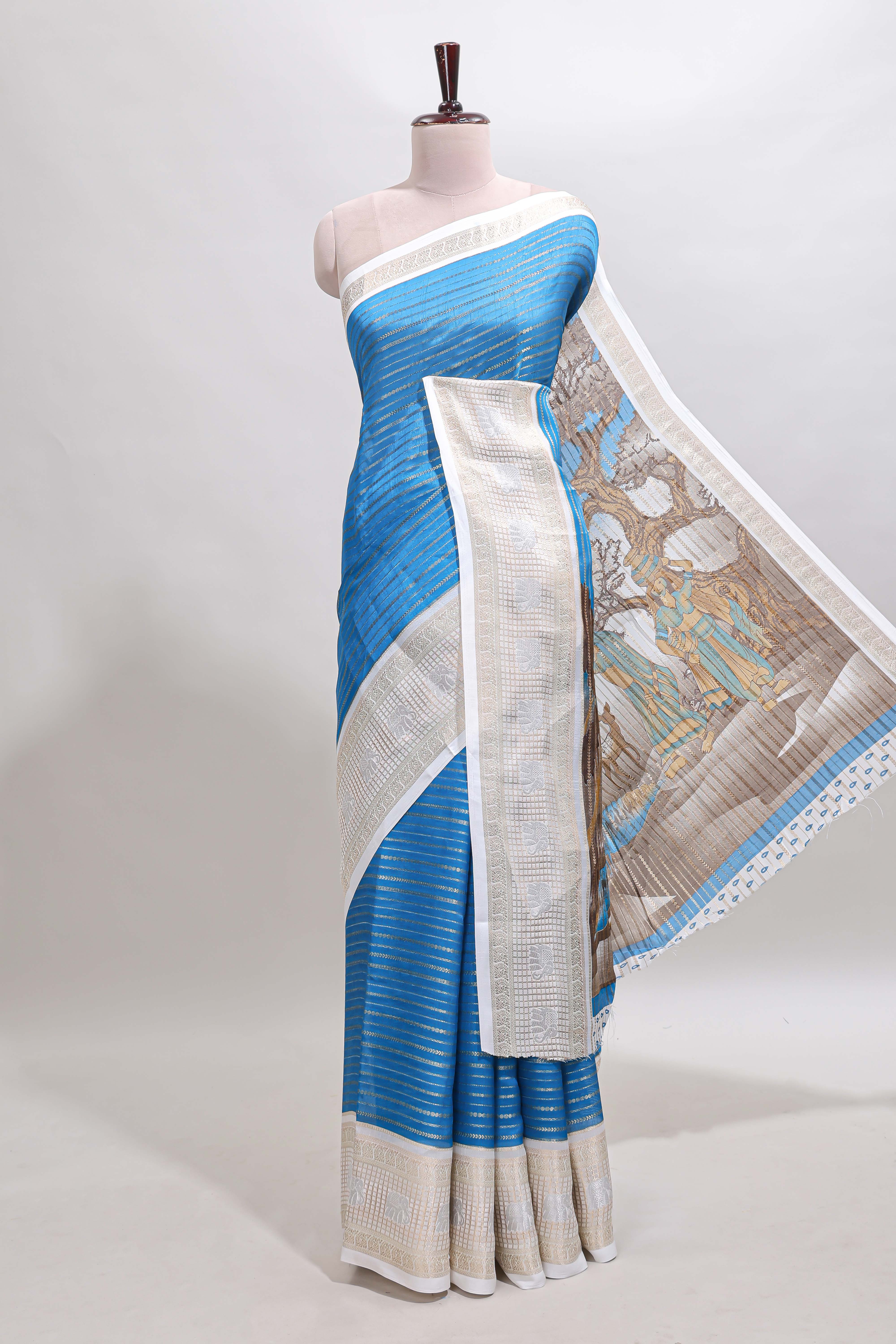 Blue zari striped dola silk saree withcontrast zari border and printed blouse