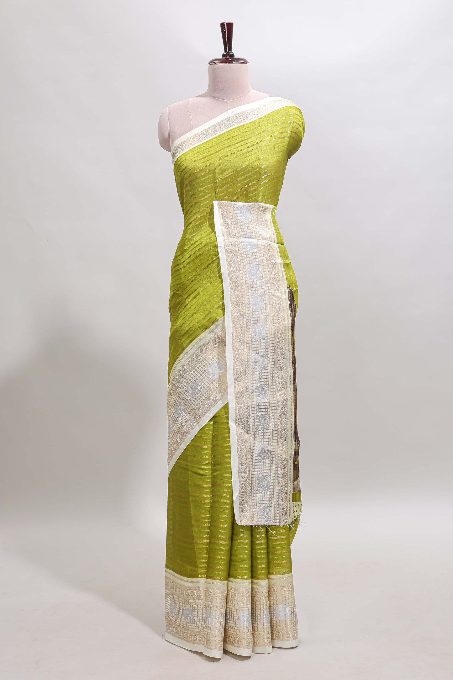 Green zari striped dola silk saree with  contrast zari border and printed blouse
