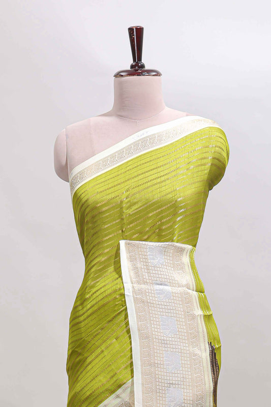 Green zari striped dola silk saree with  contrast zari border and printed blouse