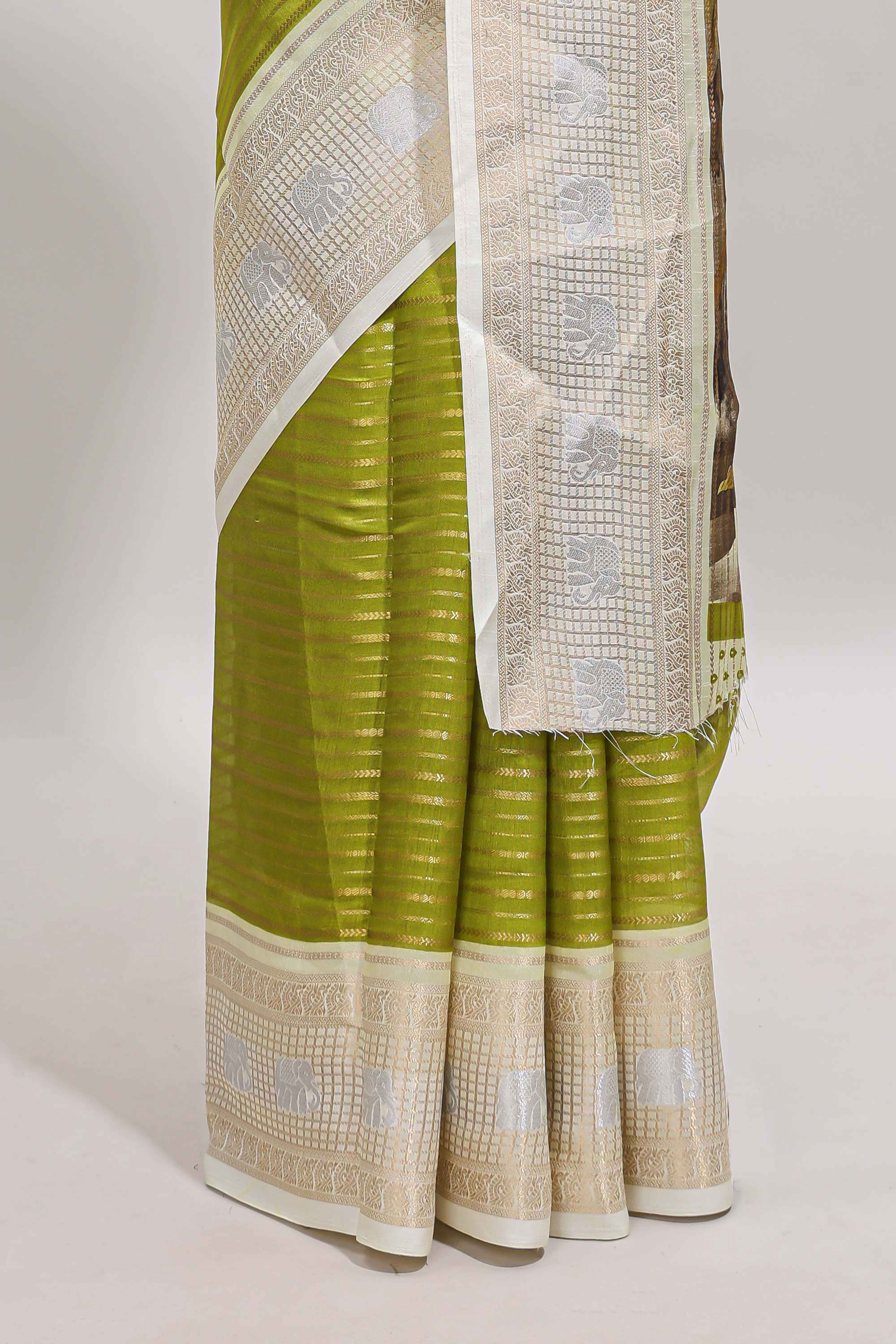 Green zari striped dola silk saree withcontrast zari border and printed blouse