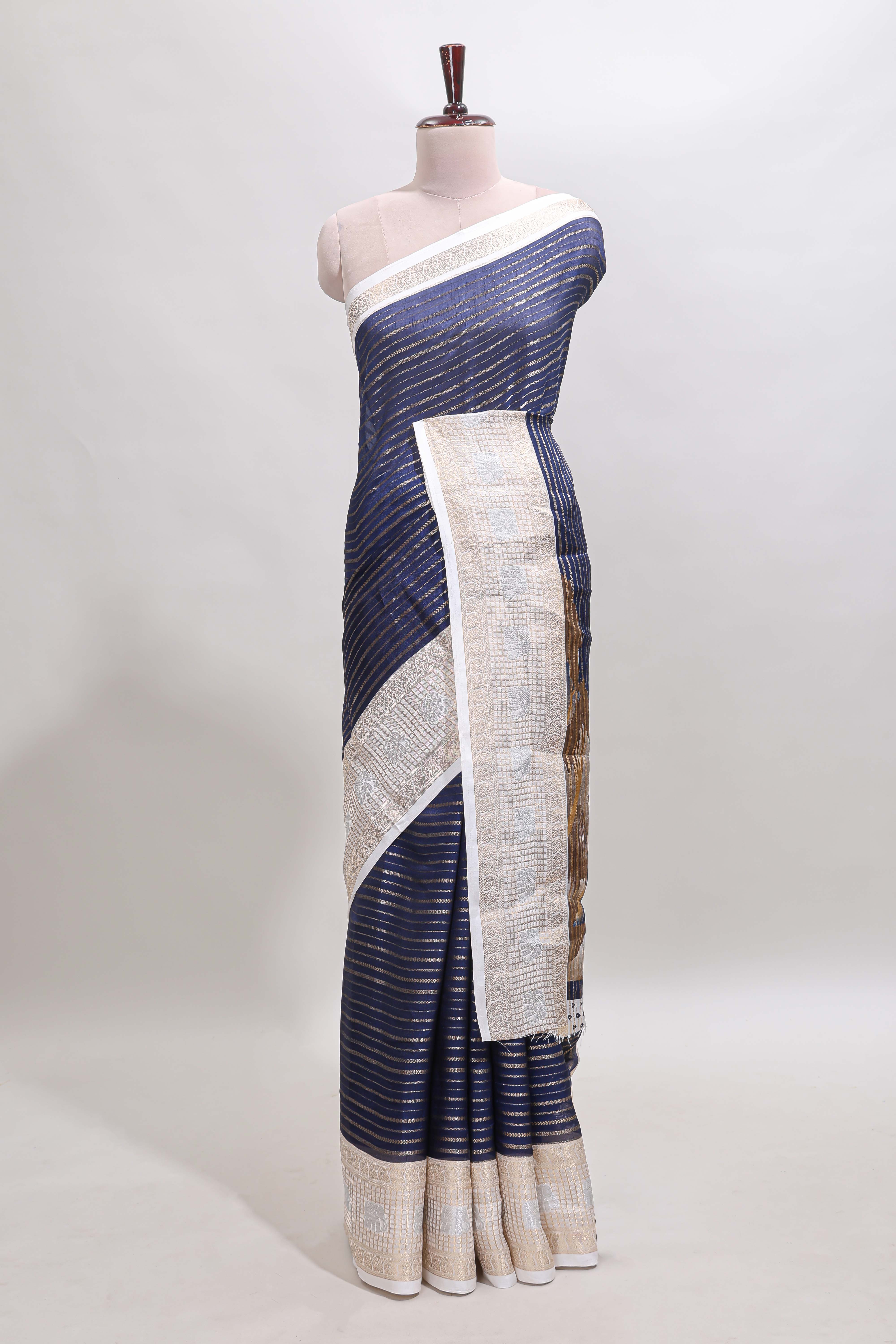 Dark blue zari striped dola silk saree withcontrast zari border and printed blouse
