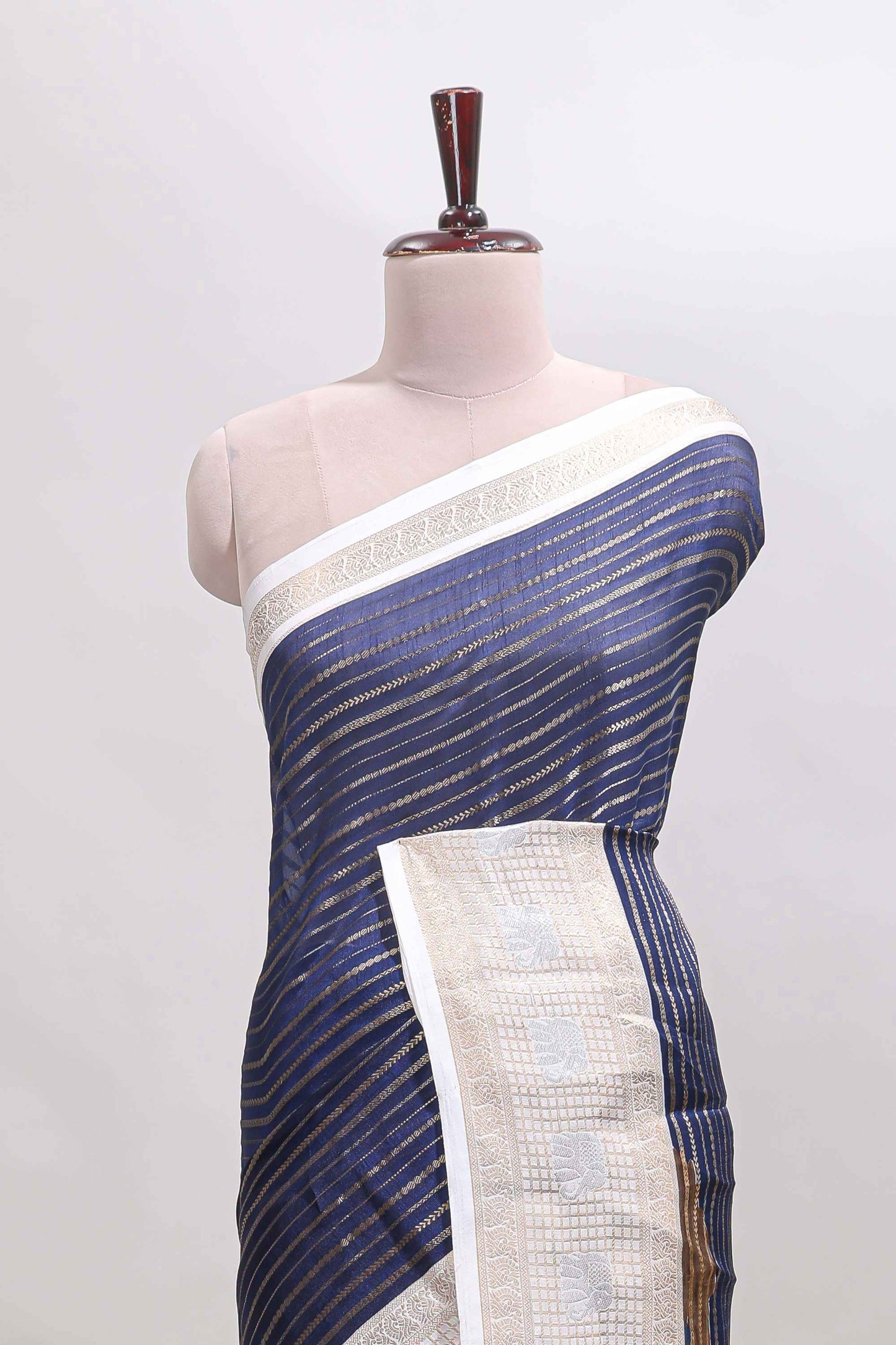 Dark blue zari striped dola silk saree with  contrast zari border and printed blouse