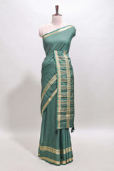 Green checked dola silk saree with self zari border and matching striped pallu