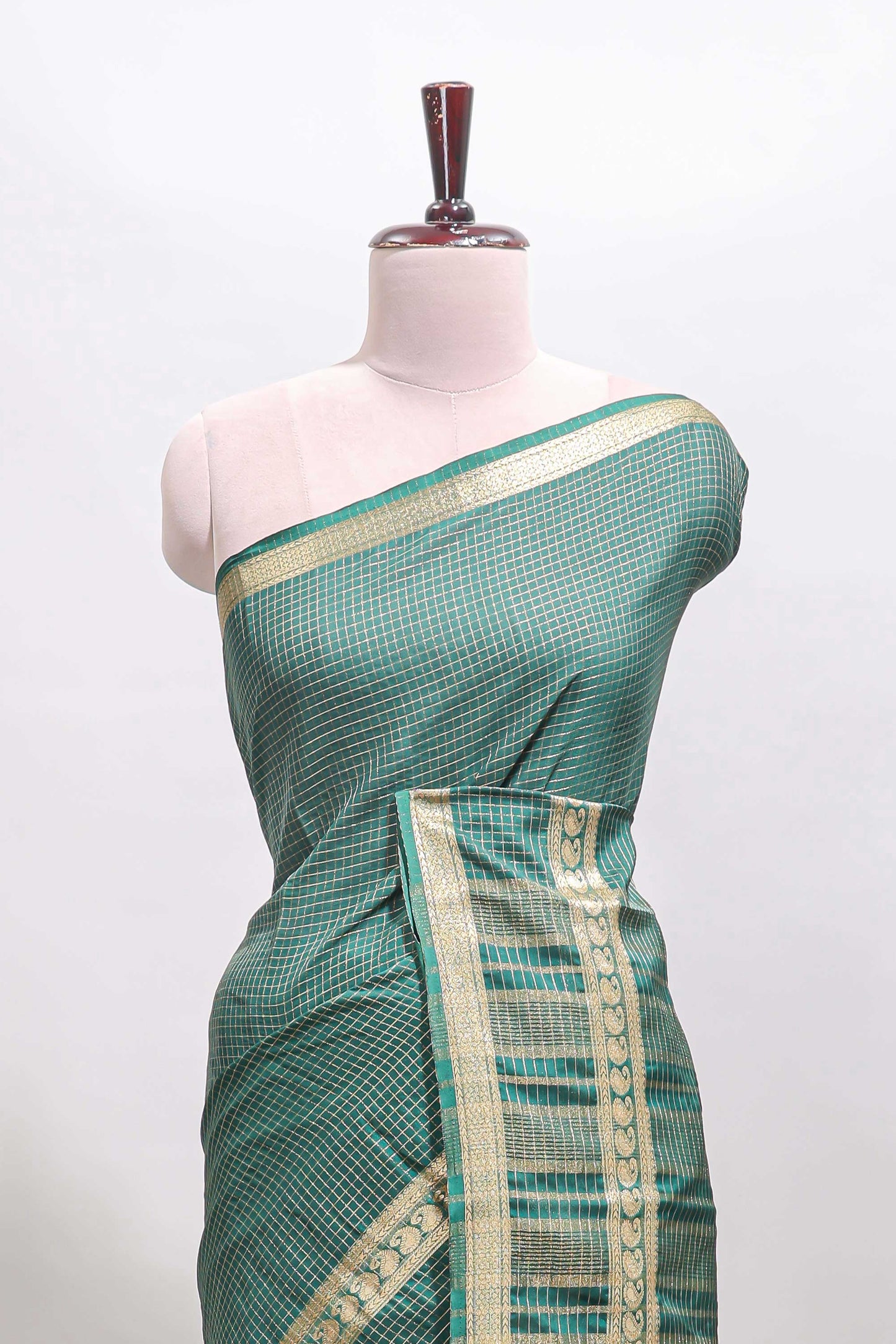 Green checked dola silk saree with self zari border and matching striped pallu
