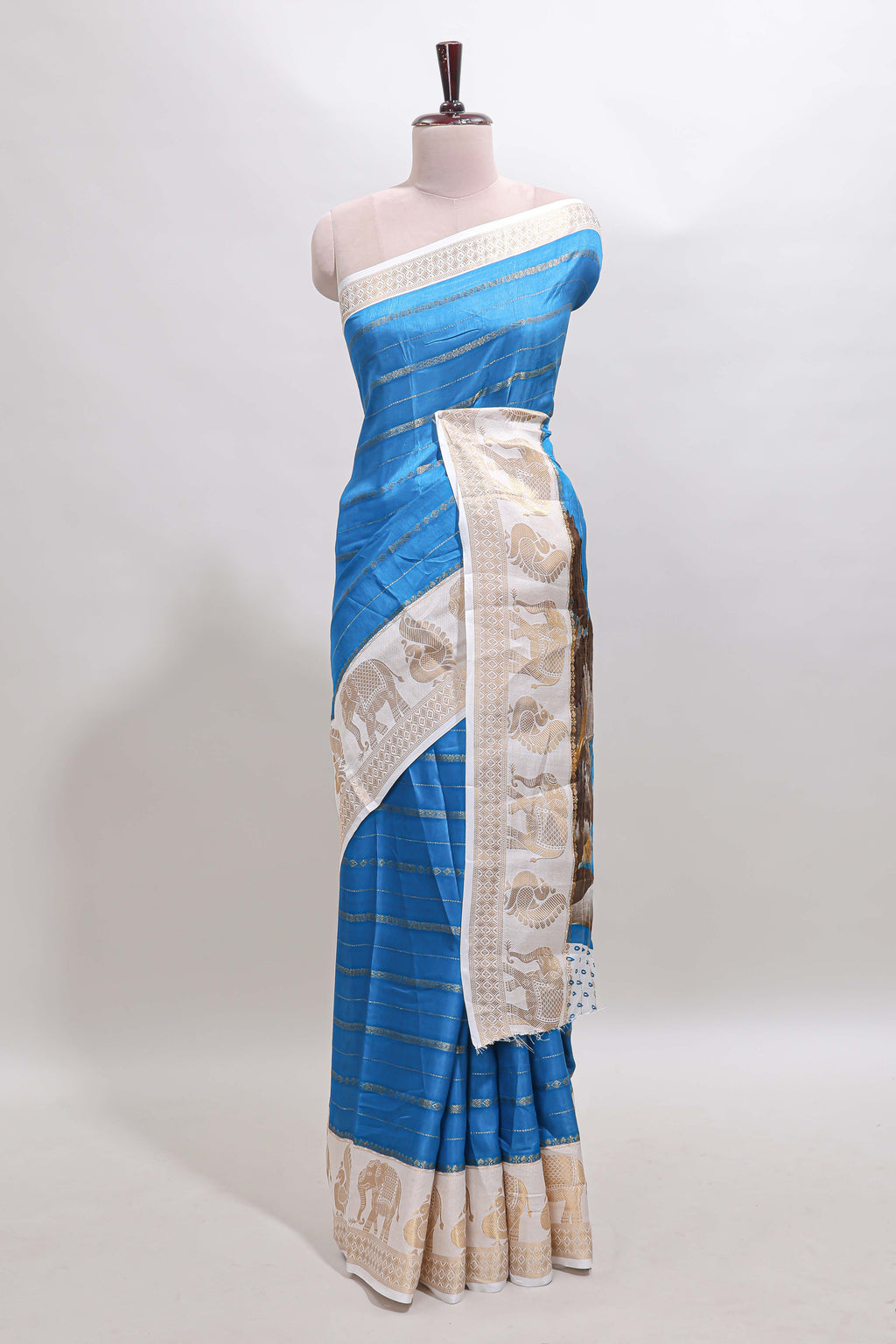 Peacock blue striped dola silk saree with contrast zari border and kalamkari style pallu