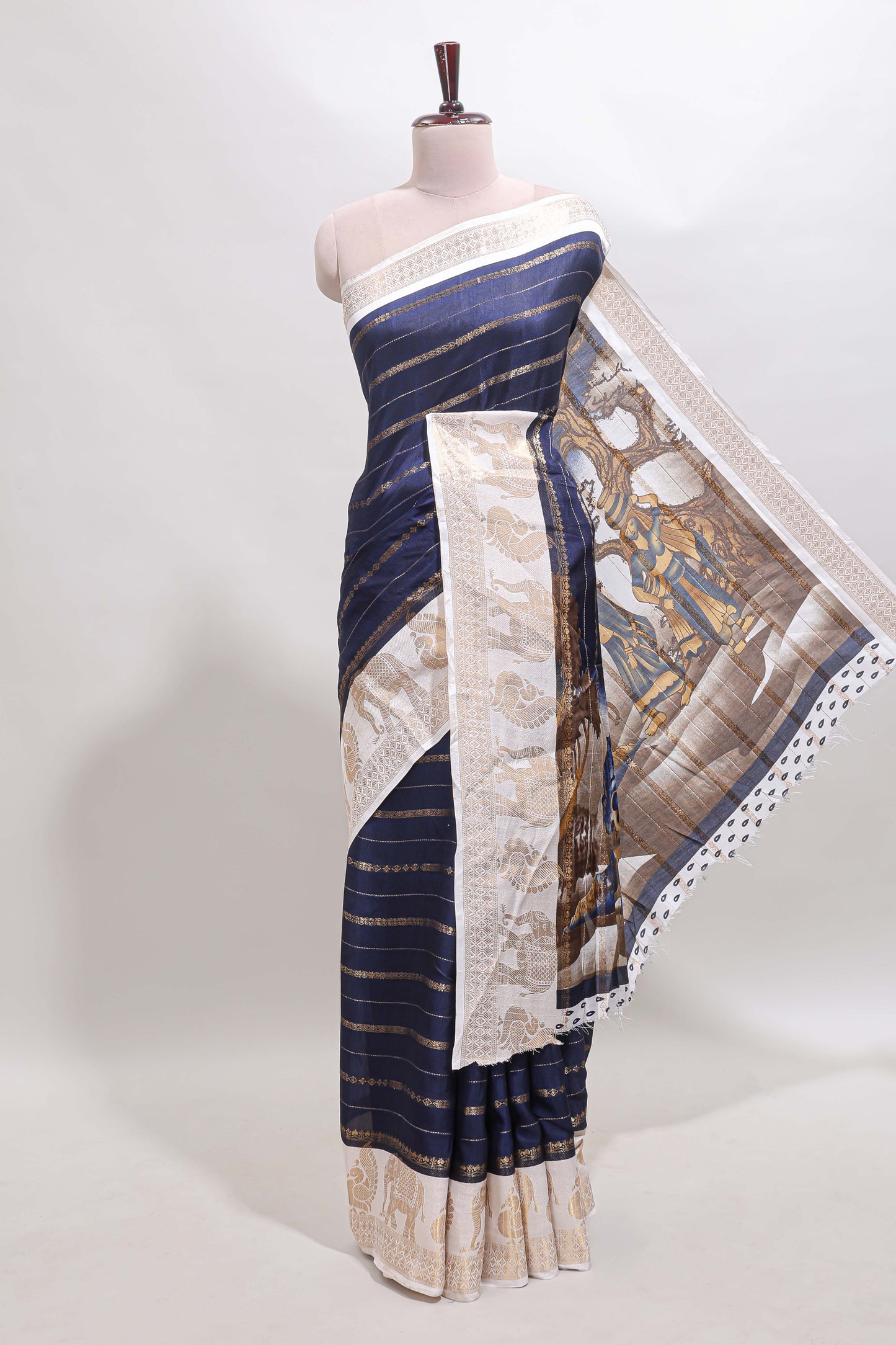 Dark blue striped dola silk saree with contrast zari border and kalamkari style pallu