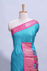 Turquoise blue dola silk saree with fine zari stripes contrastzari border and a rich peacock floral woven pallu along with printed contrast blouse