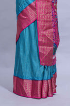 Turquoise blue dola silk saree with fine zari stripes contrast  zari border and a rich peacock floral woven pallu along with printed contrast blouse