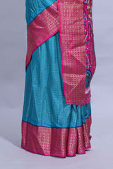 Turquoise blue dola silk saree with fine zari stripes contrastzari border and a rich peacock floral woven pallu along with printed contrast blouse