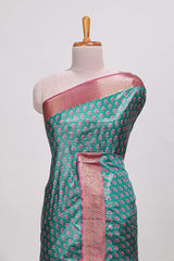 Bottle green dola silk saree with contrast coper gold zari border and contrast blouse