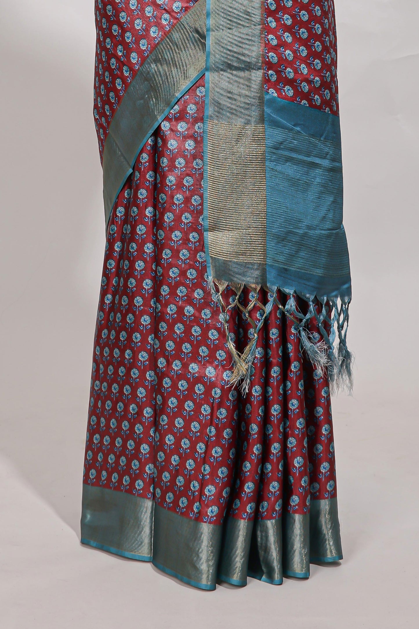 Maroon dola silk saree with contrast coper gold zari border and contrast blouse