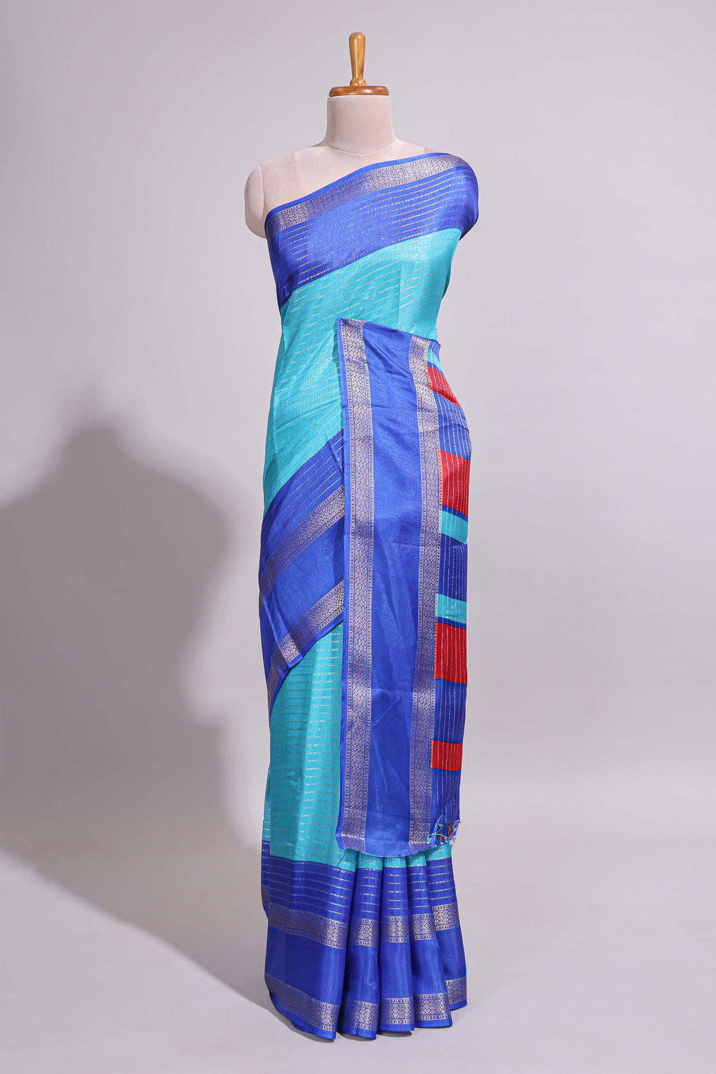 Turquoise green zari striped dola silk saree with contrast border and floral printed blouse