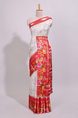 Off white floral design dola silk saree with contrast red border and printed motifs blouse