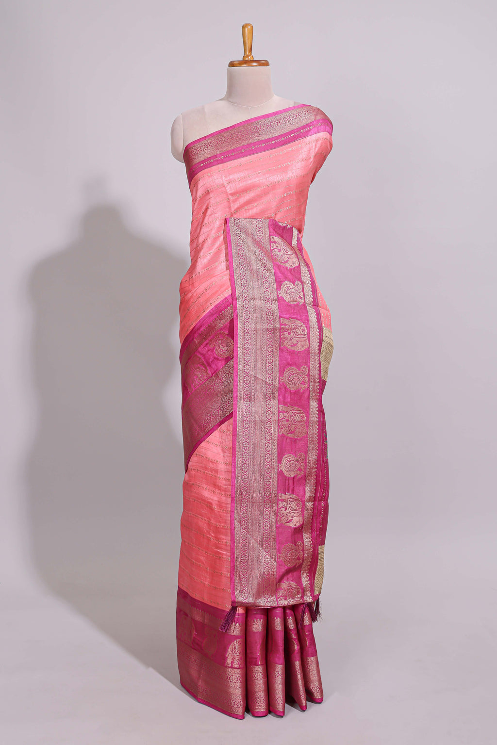 Peach zari striped dola silk saree with contrast zari border and floral printed pallu