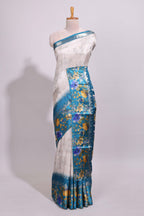 Off white floral design dola silk saree with contrast turquoise green floral border and printed motifs blouse