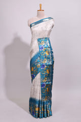 Off white floral design dola silk saree with contrast turquoise green floral border and printed motifs blouse