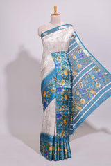 Off white floral design dola silk saree with contrast turquoise green floral border and printed motifs blouse