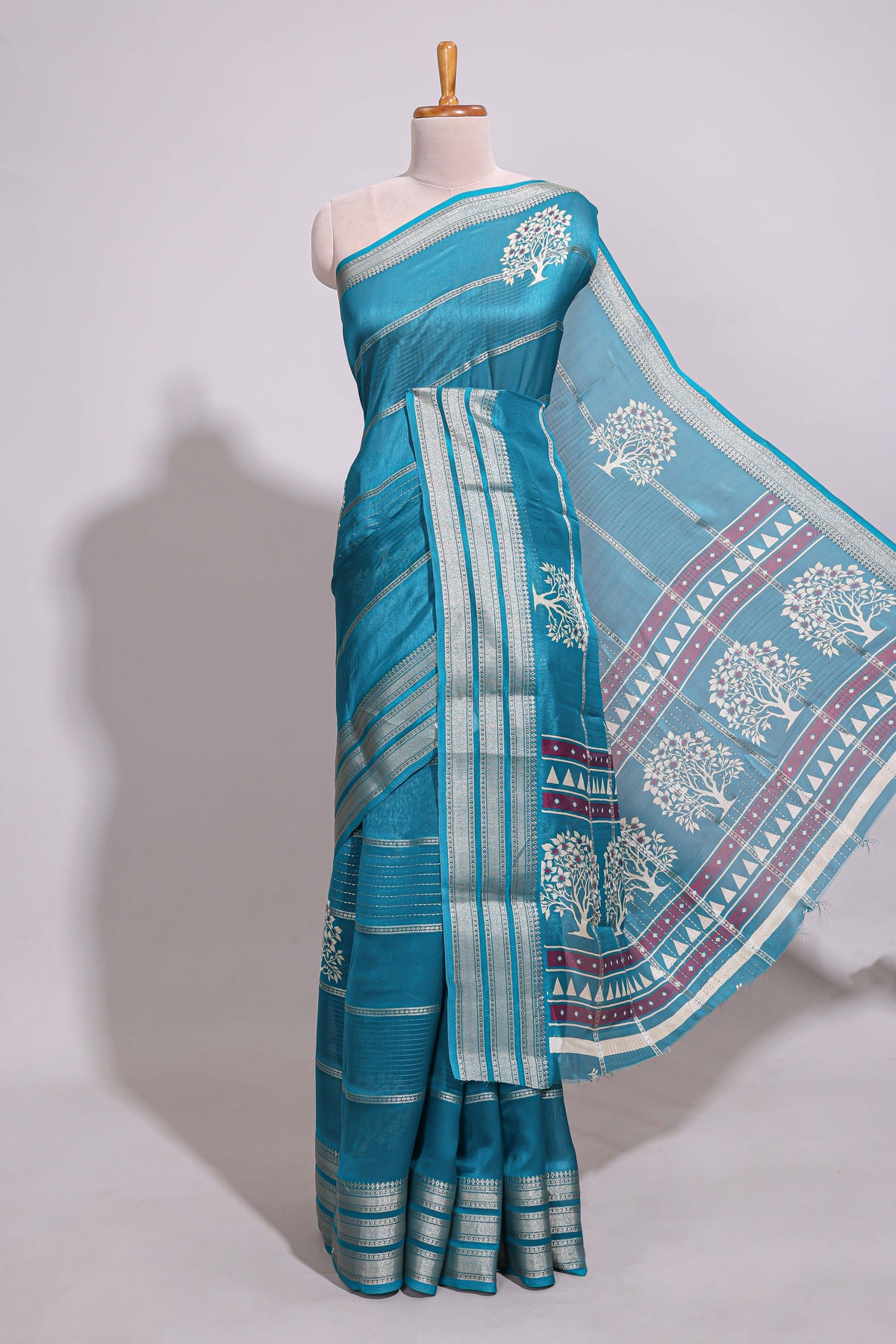 Teal blue Dola silk saree all over zari lines and motifs design with silver zari  border and self printed pallu and matching blouse