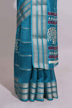 Teal blue Dola silk saree all over zari lines and motifs design with silver zari  border and self printed pallu and matching blouse