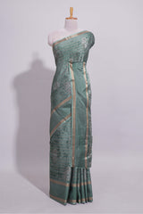 Teal green Dola Silk Saree all over floral motifs fine zari stripes and zari border with matching printed blouse