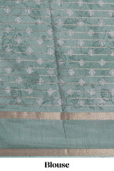 Teal green Dola Silk Saree all over floral motifs fine zari stripes and zari border with matching printed blouse