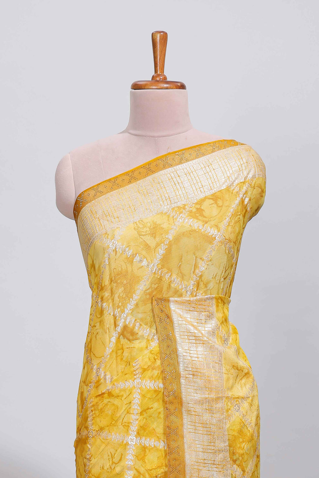 Yellow checked floral theme dola silk saree with self border and matching blouse