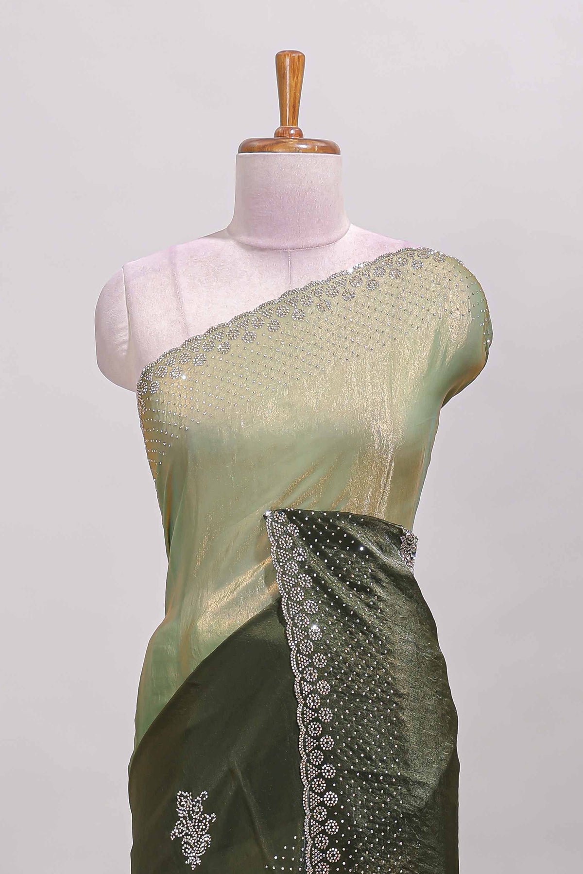 Green dual shade designer saree with floral motifs, stone work & scallop border