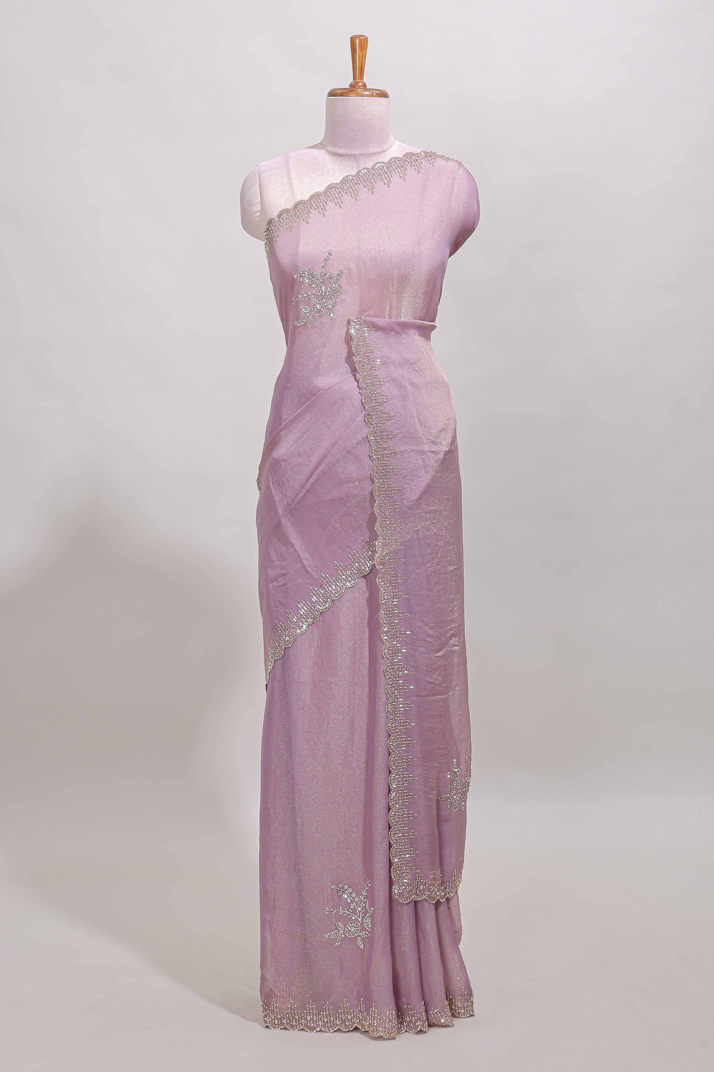 Lavender designer saree with floral motifs, stone work & scallop border