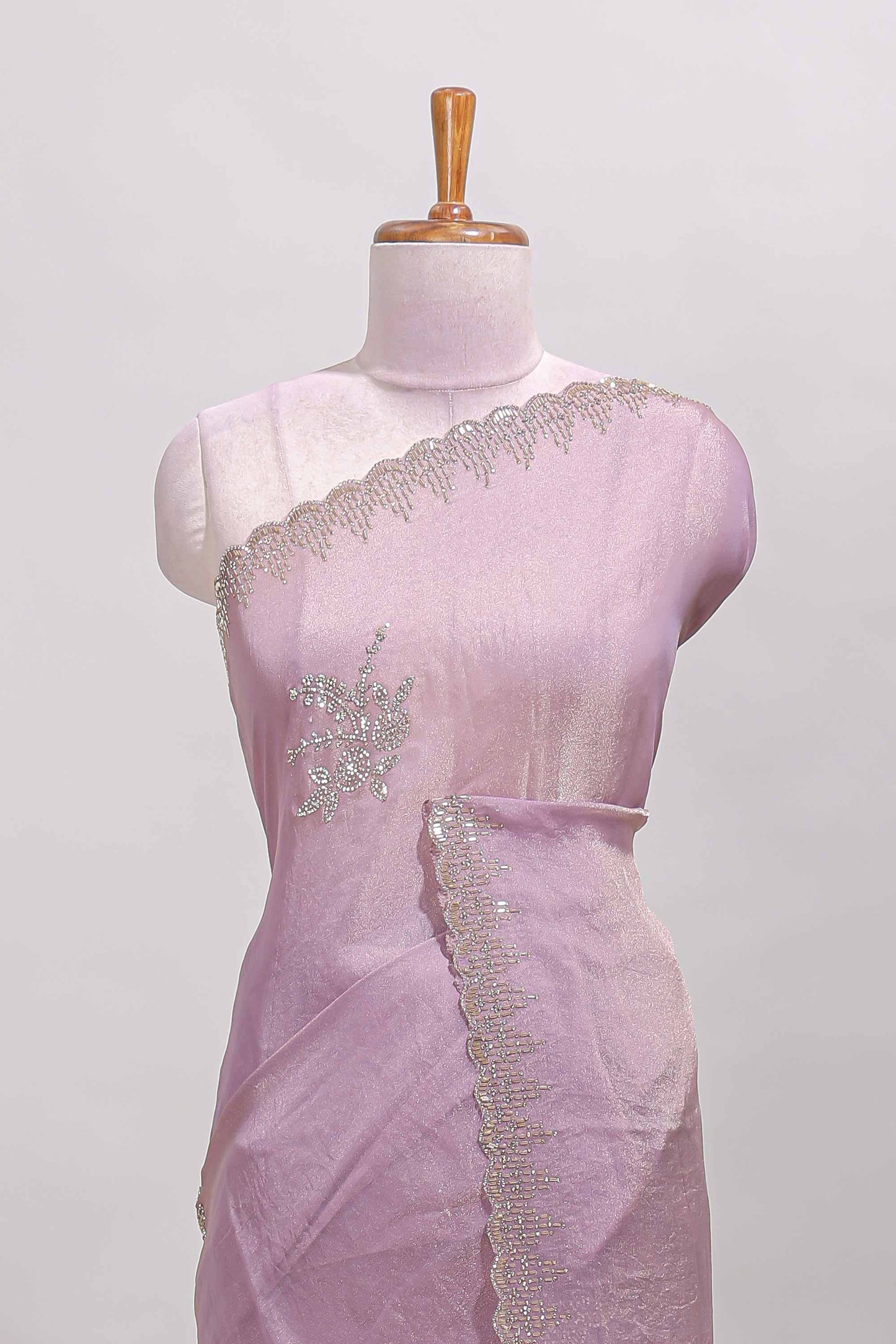 Lavender designer saree with floral motifs, stone work & scallop border