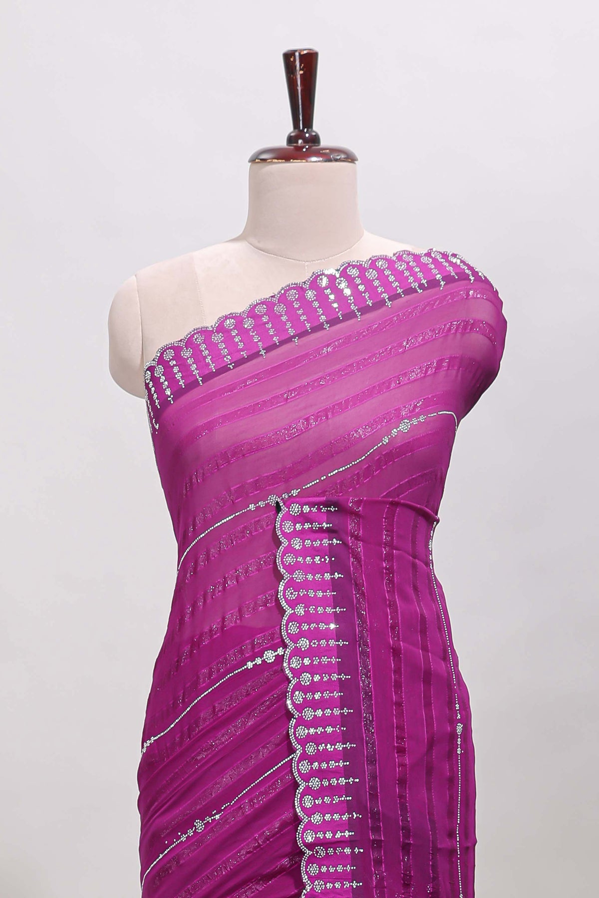 Dark magenta striped design stone work designer saree with self floral scallop border and matching blouse