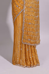 Mustard yellow saree with elegant sequin embellishments and a shimmering border along with matching blouse
