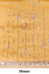 Mustard yellow saree with elegant sequin embellishments and a shimmering border along with matching blouse