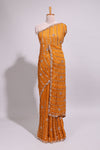 Orange saree with elegant sequin embellishments and a shimmering border along with embroidered blouse piece