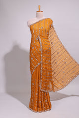 Orange saree with elegant sequin embellishments and a shimmering border along with embroidered blouse piece