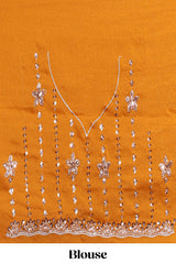 Orange saree with elegant sequin embellishments and a shimmering border along with embroidered blouse piece