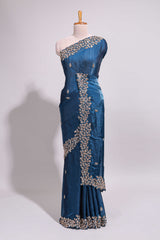 Royal blue saree with elegant golden floral embroidery and a rich embellished border along with embroidered blouse piece