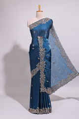 Royal blue saree with elegant golden floral embroidery and a rich embellished border along with embroidered blouse piece