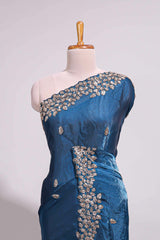 Royal blue saree with elegant golden floral embroidery and a rich embellished border along with embroidered blouse piece