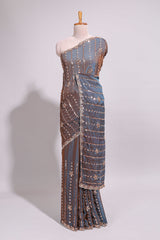 Steel blue saree with silver sequin floral motifs vertical stripe detailing and an embellished border along with blouse